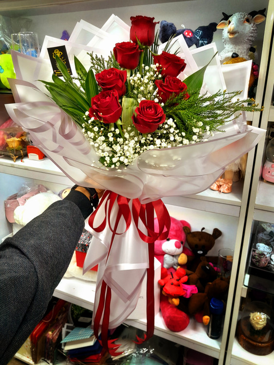 دستهگل رز ۷ شاخهای با کاغذ پیچی اختصاصی – هدیهای لوکس از برند فلوریست ارومیه | تحویل در ارومیه